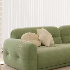 cloud sofa with a button-tufted rounded back, broad seat cushions and a low lounge profile