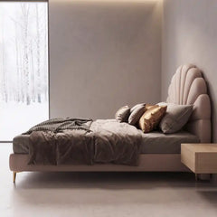 bed with headboard shown in a spacious bed layout with shell-shaped padded headboard