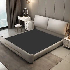 storage bed shown in a compact double-bed layout with thick padded headboard
