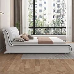 upholstered bed showing the lift-up storage area with curved padded headboard