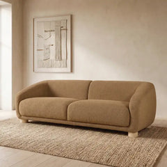 Boucle sofa with thick rounded arms and natural wooden legs, right-side view
