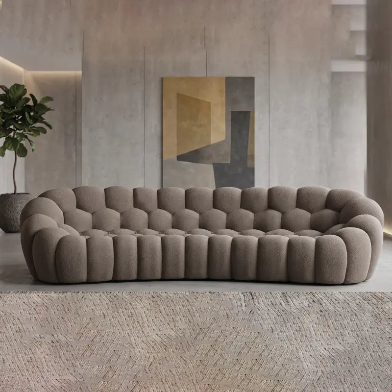 Boucle sofa with thick rounded cushions and padded arms, right-side view