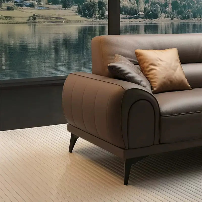 Leatherette sofa with rounded padded arms and elevated legs, right-side view