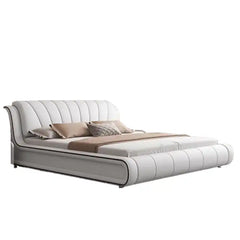 platform bed shown in a spacious bed layout with curved padded headboard