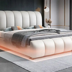 hydraulic bed shown with a balanced mattress layout with curved padded headboard