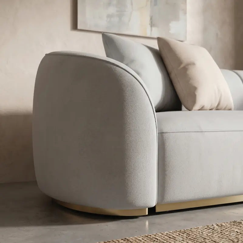 curved sofa with seamless rounded edges and sculptural front profile, armrest close-up