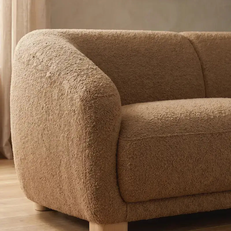 Fabric sofa with thick rounded arms and natural wooden legs, full seating layout