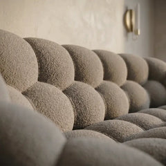 Lounge sofa with thick rounded cushions and padded arms, full seating layout
