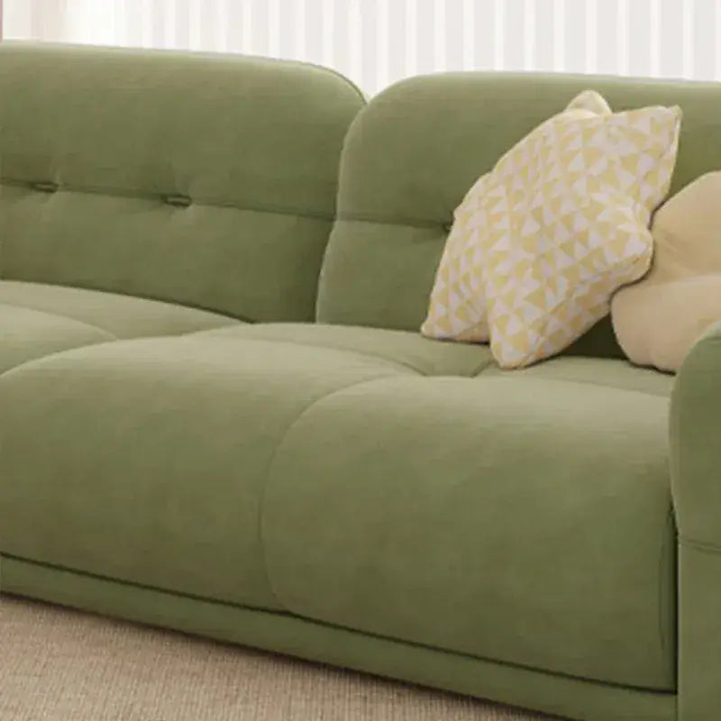 cloud sofa with a curved backrest, sage green upholstery and hidden low legs