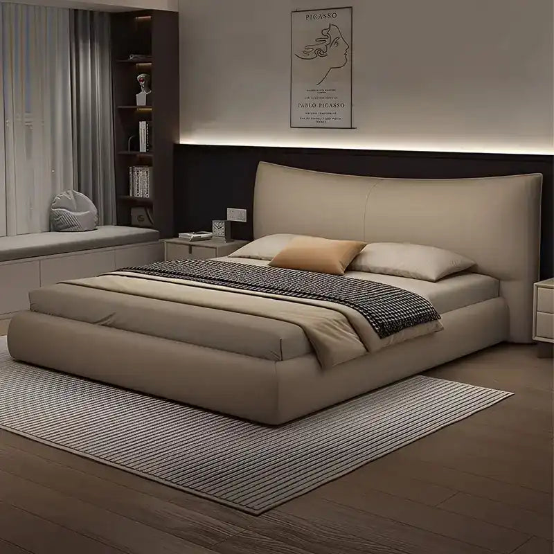 low profile platform bed shown in a compact double-bed layout with curved padded headboard
