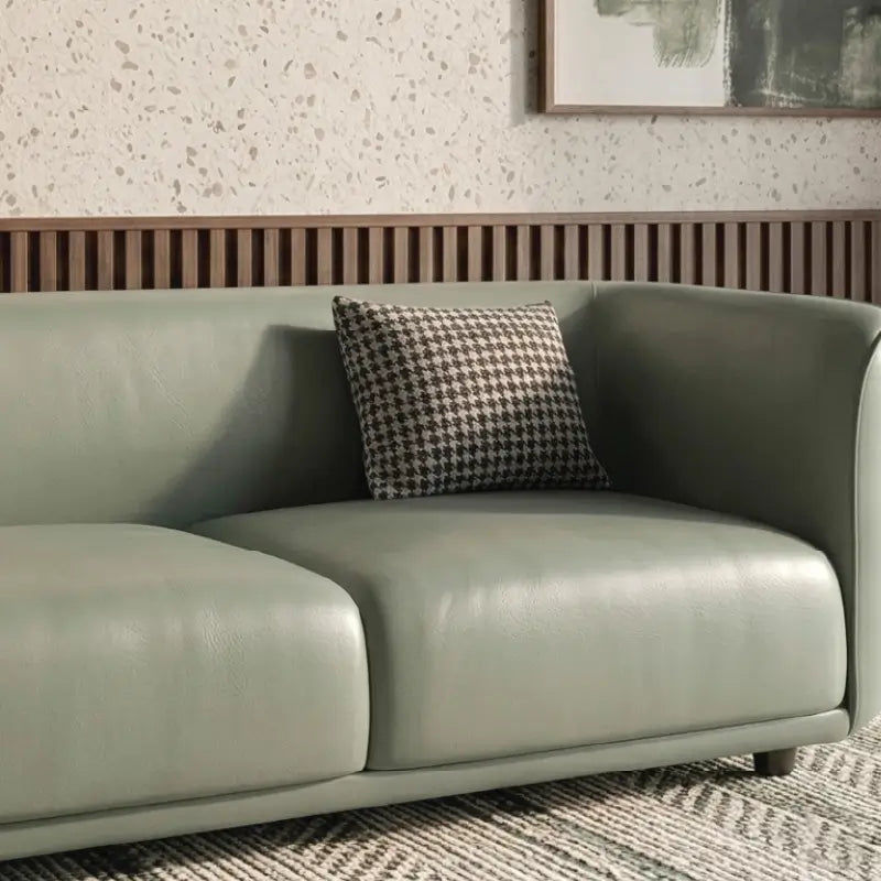 Lounge sofa with soft rounded arms and low wraparound backrest, close-up of back cushions