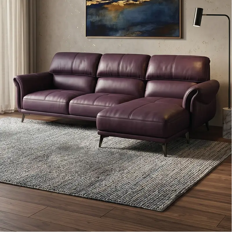 Designed with a sleek rectangular profile, curved arm detailing, and elevated metallic legs, this leather sofa