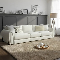 Corner sofa with curved arms and wooden accent details, close-up of back cushions
