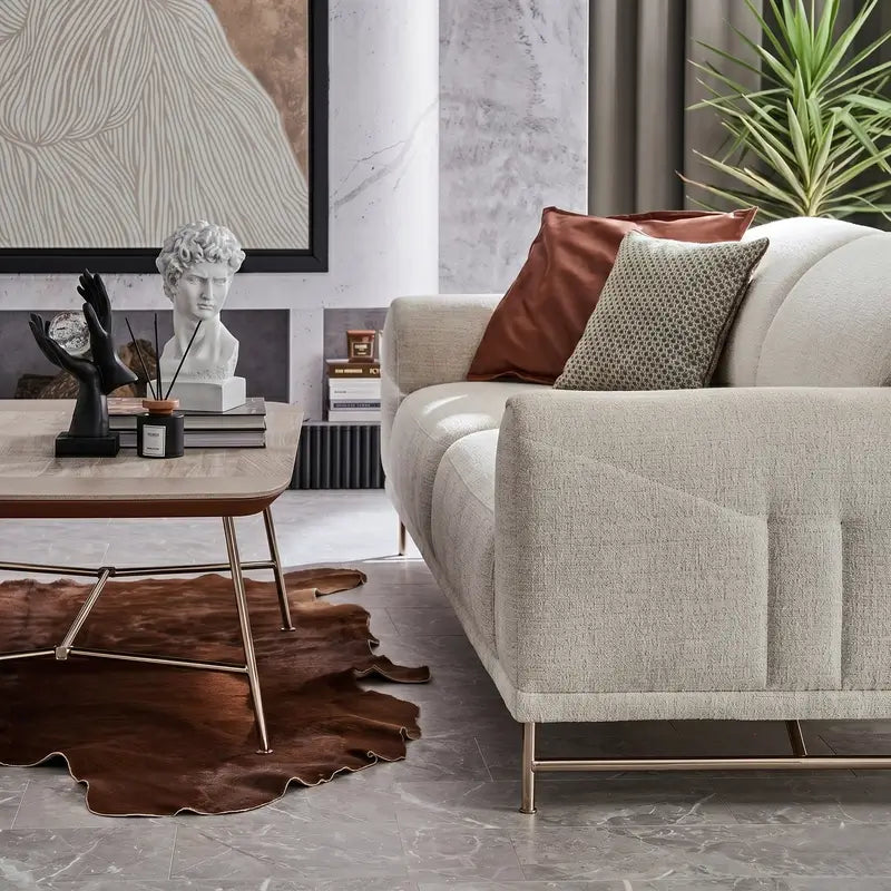 Boucle sofa with rounded cushioned arms and metallic legs, close-up of back cushions