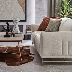 Boucle sofa with rounded cushioned arms and metallic legs, close-up of back cushions