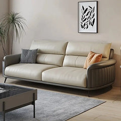 The sleek flared arms and stitched details lend it a settee-like elegance, while matte black metal legs give the piece an airy silhouette.