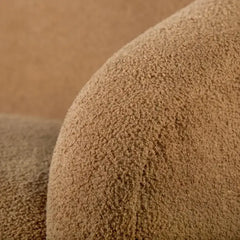 Boucle sofa with thick rounded arms and natural wooden legs, armrest detail