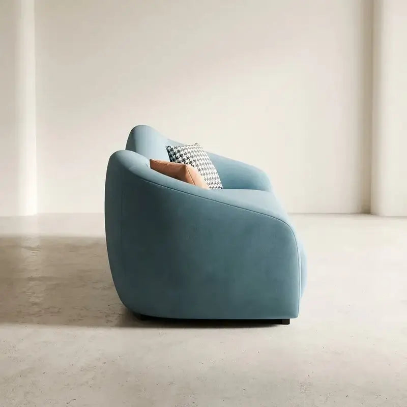 Shown in aqua blue fabric with a velvet-look finish and ivory beige upholstery