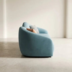 Shown in aqua blue fabric with a velvet-look finish and ivory beige upholstery